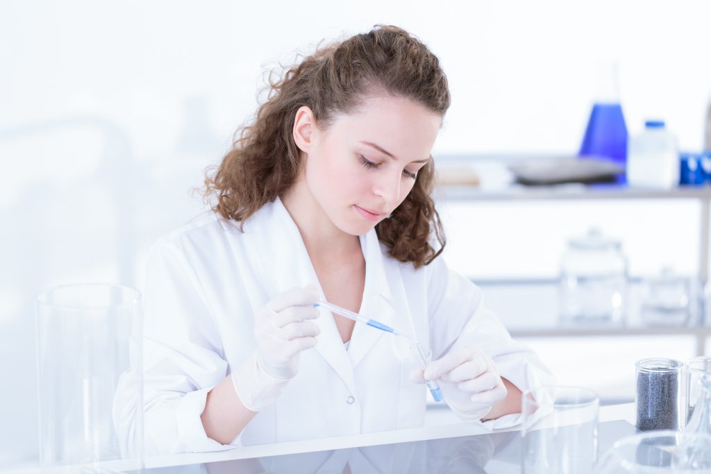 Young scientist analyzing a chemical substance in a lab